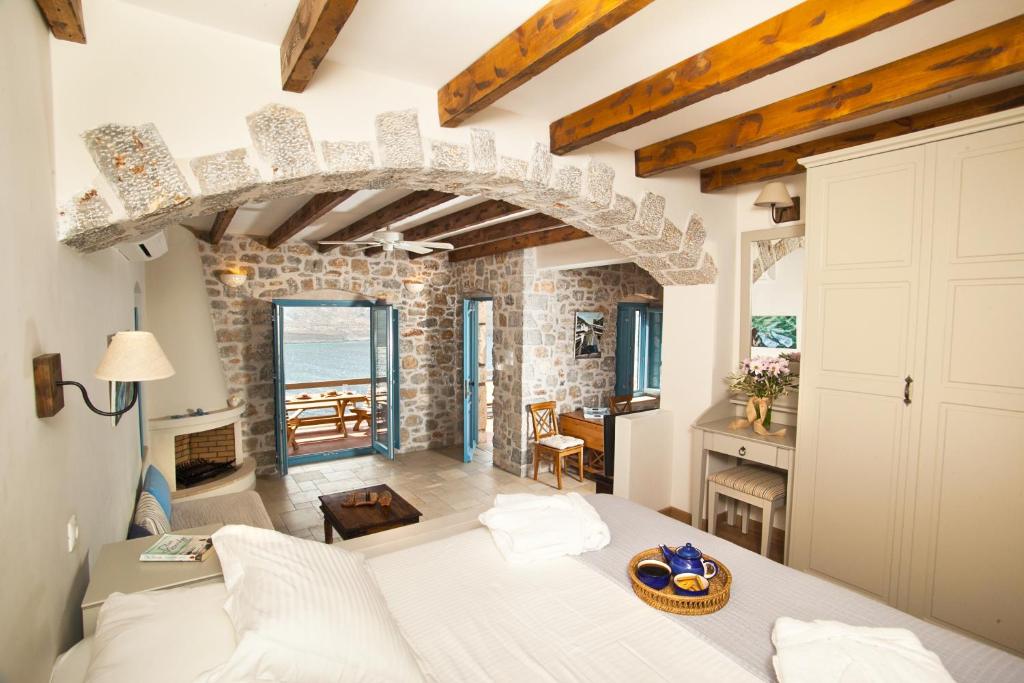 a bedroom with a bed and a living room at Petra Boutique Homes in Aryinónda