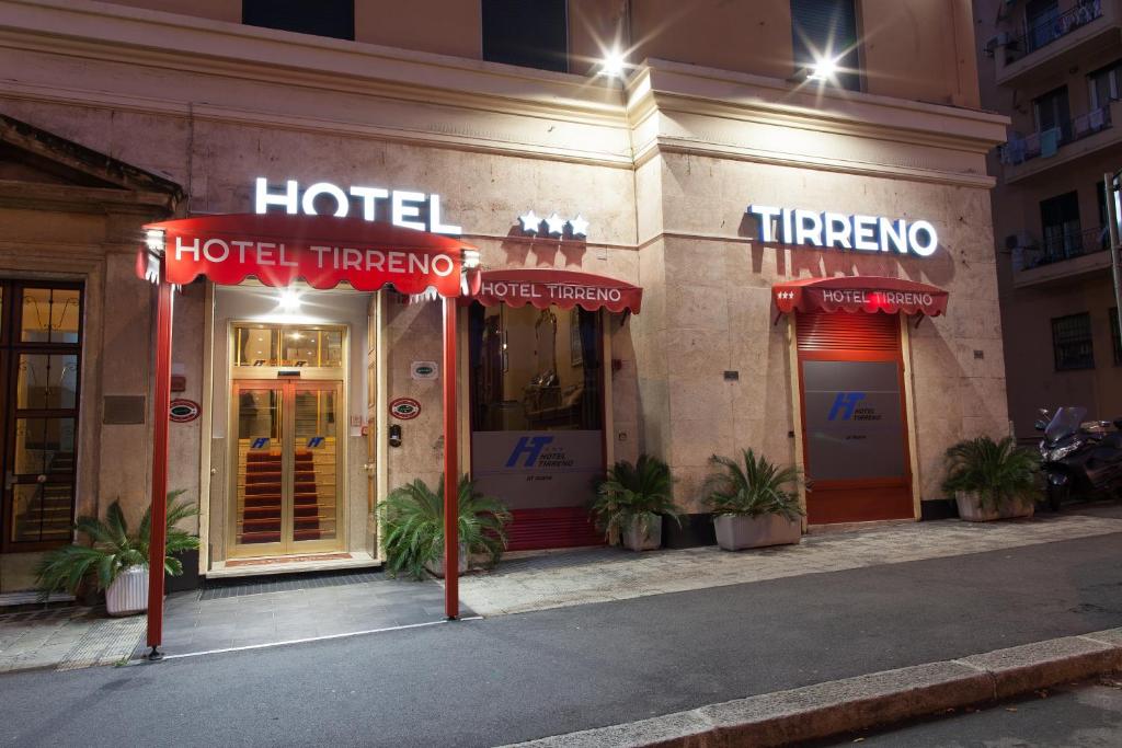 a hotel with neon signs on the front of a building at Hotel Tirreno in Genoa