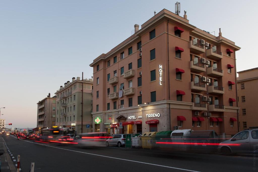 a building on the side of a city street with cars at Hotel Tirreno in Genoa