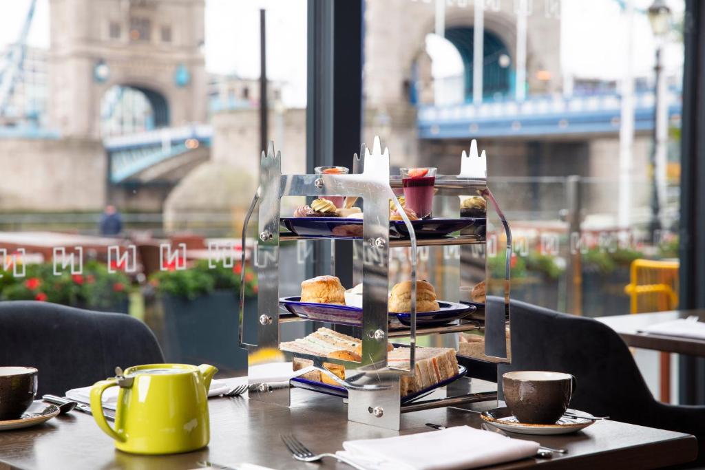 a table with a tray of food on top at The Tower Hotel, by Thistle in London