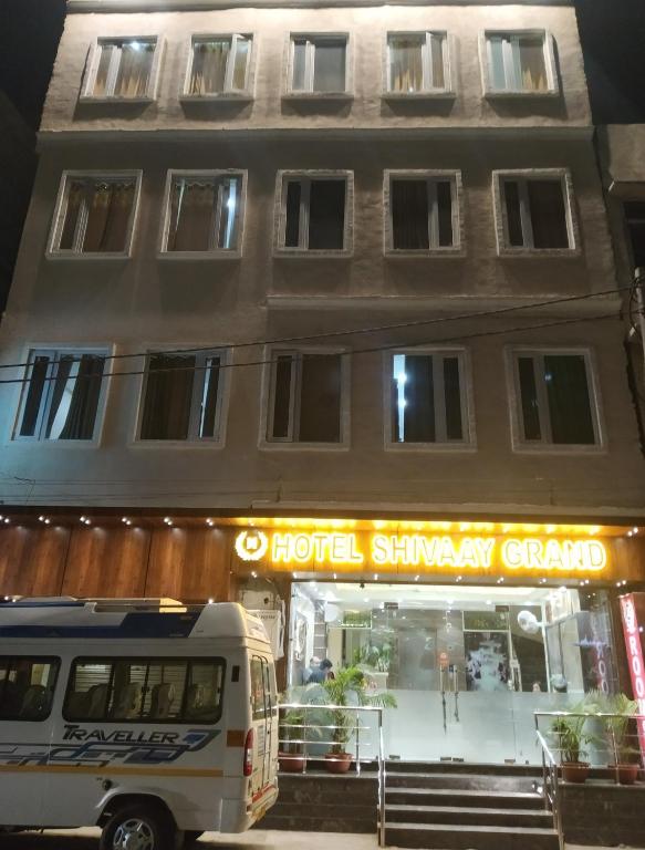 a bus parked in front of a hotel shawarma garage at Hotel Shivaay Grand in Amritsar
