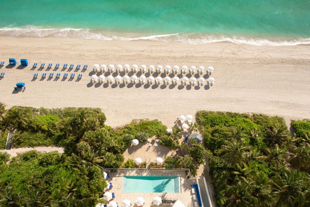 an overhead view of a beach with a row of beach umbrellas at Sole Miami, A Noble House Resort in Miami Beach