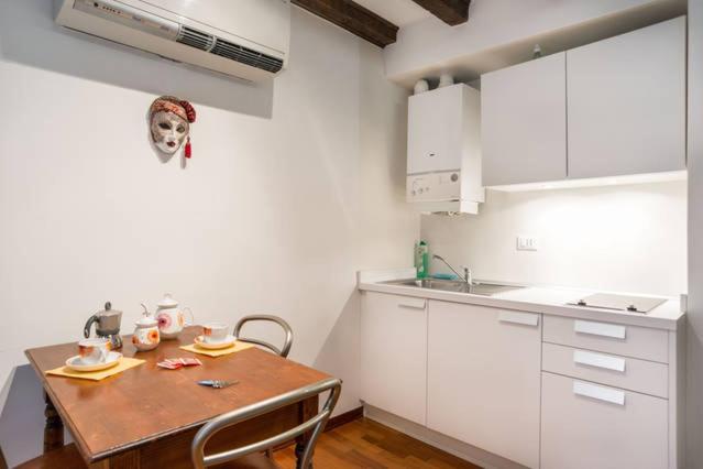 a kitchen with a table with a skull on the wall at Studio in San Marco square in Venice