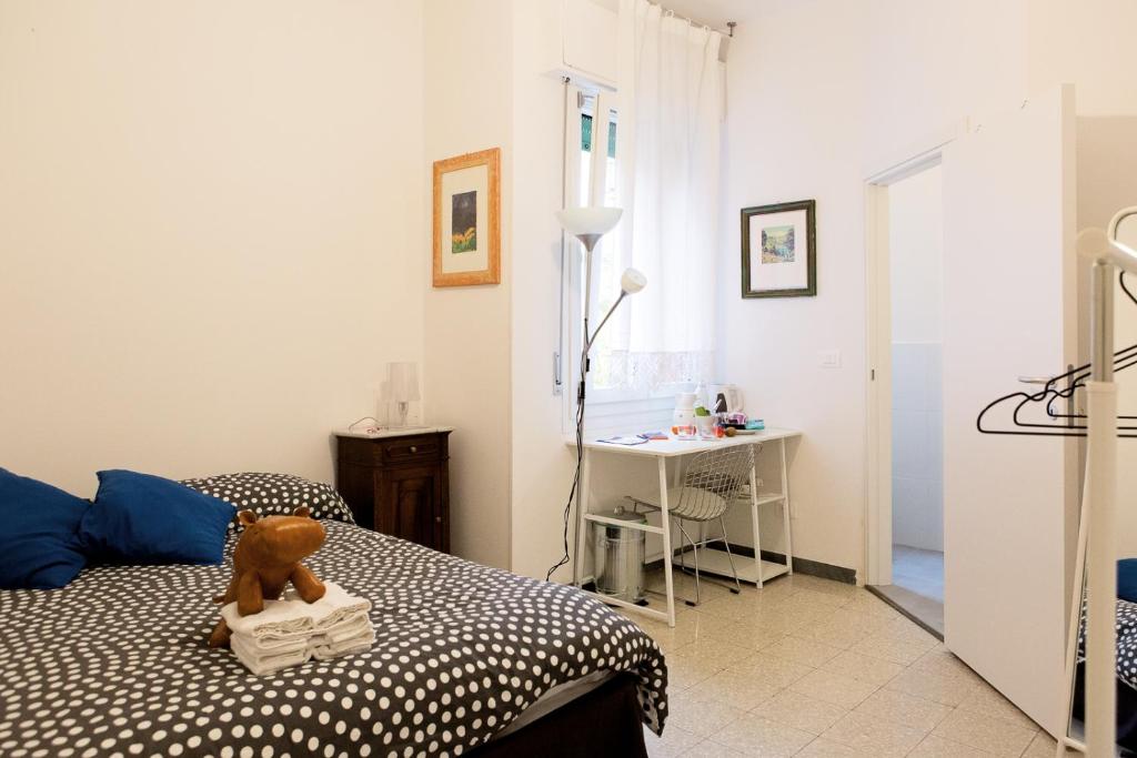 a bedroom with a bed with a teddy bear on it at Interno 7, tra la Fiera ed il Centro in Bologna