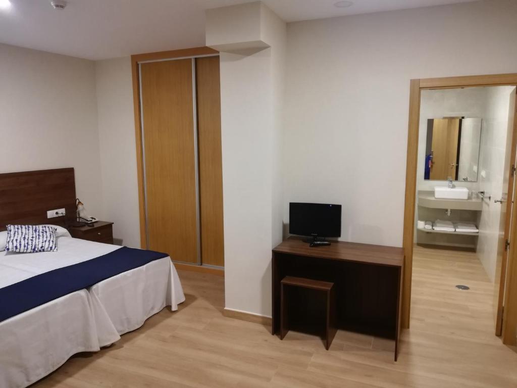 Łóżko lub łóżka w pokoju w obiekcie Hosteria de Rafi