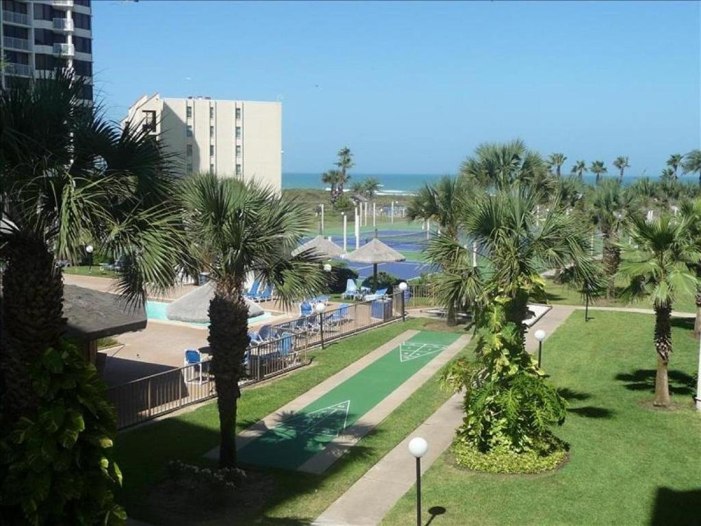a view of a park with palm trees and a tennis court at Saida IV Condos S4308 in South Padre Island