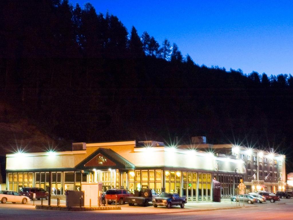 a building with cars parked in a parking lot at night at First Gold Gaming Resort in Deadwood