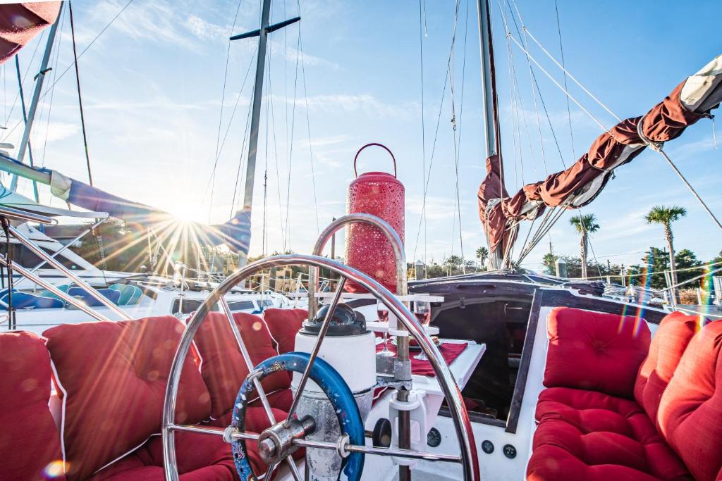 a boat with red seats and the sun shining at Romantic Escape in Downtown St Augustine in Saint Augustine