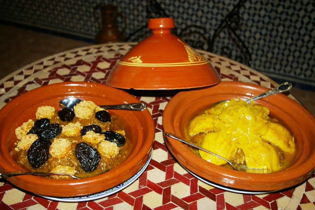 two bowls of food sitting on a table at Riad Fes Kettani in Fez