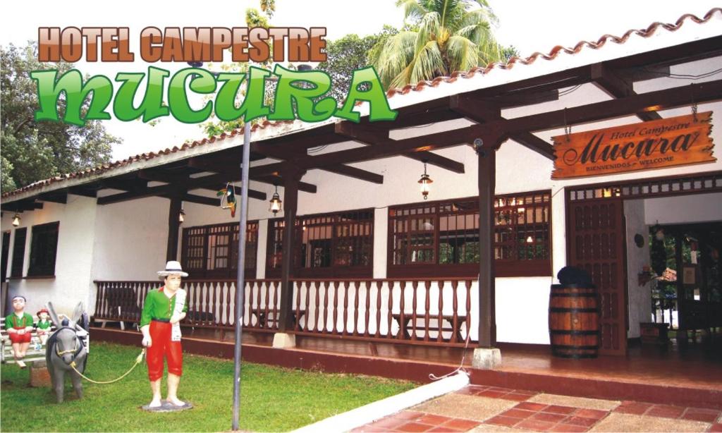 a person standing in front of a hotel at Hotel Campestre Mucura in Melgar