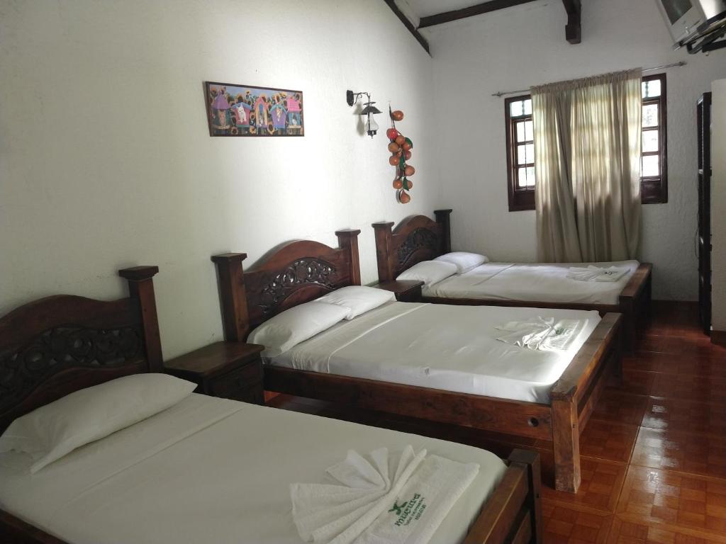 Postel nebo postele na pokoji v ubytování Hotel Campestre Mucura