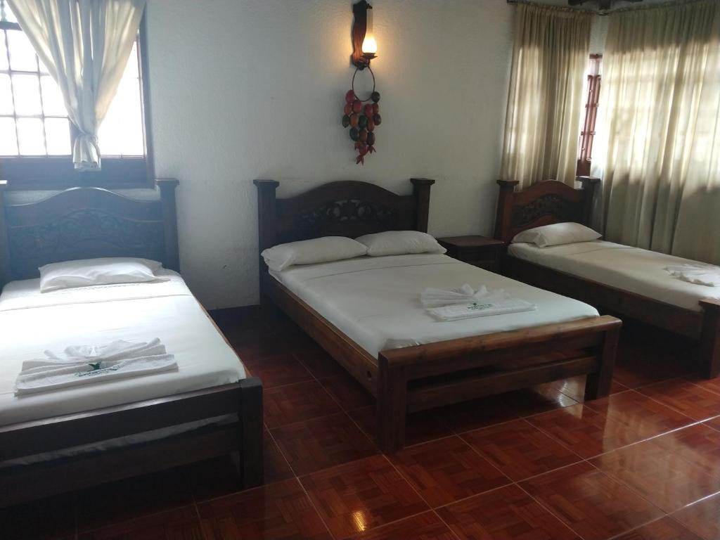 Postel nebo postele na pokoji v ubytování Hotel Campestre Mucura