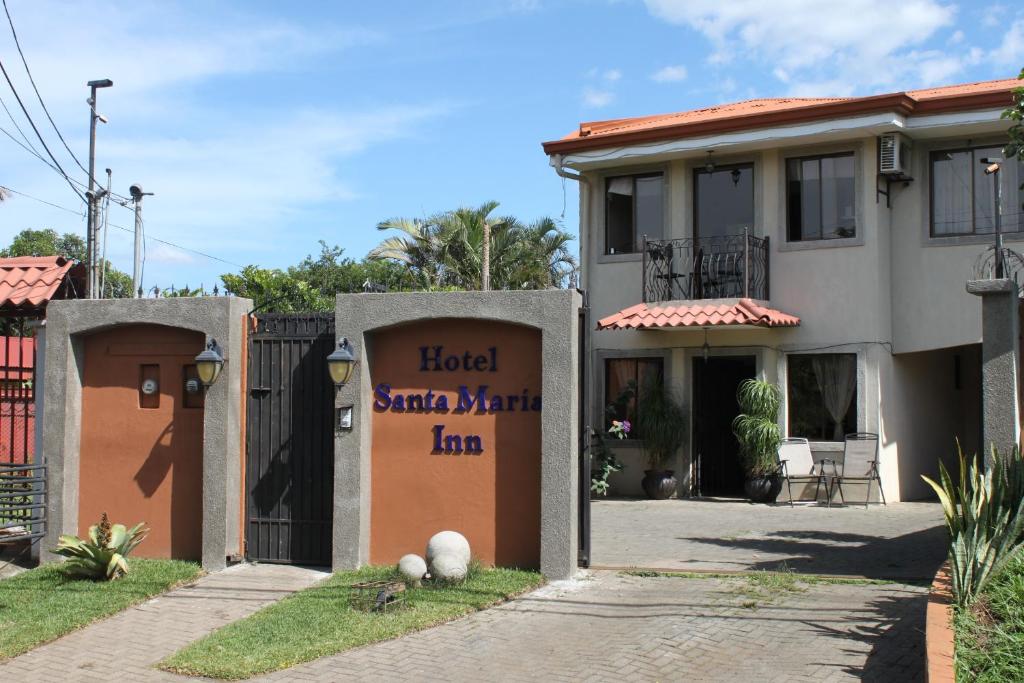 a house with a sign that reads hotel santa marta la at Hotel Santa Maria Inn in Alajuela City