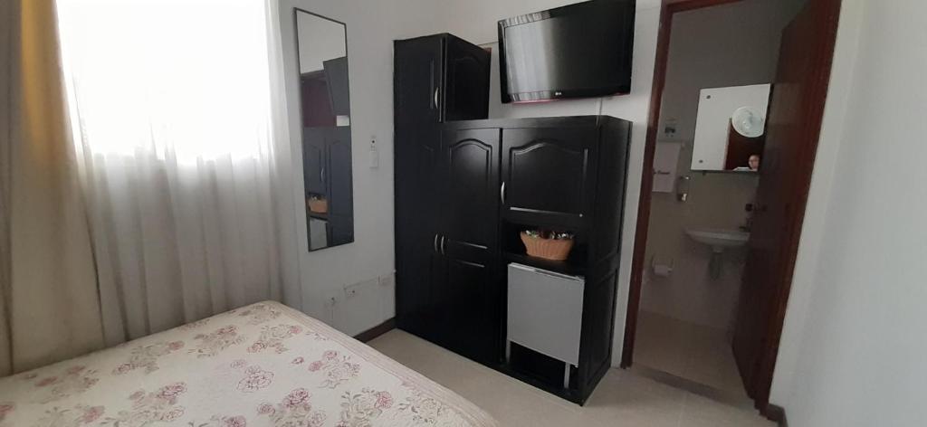 Postel nebo postele na pokoji v ubytování Hotel Colonial