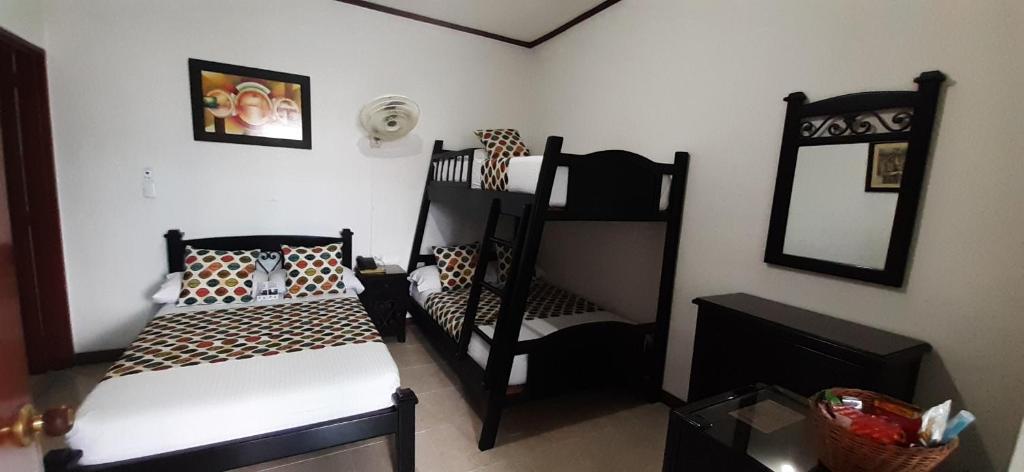 Postel nebo postele na pokoji v ubytování Hotel Colonial