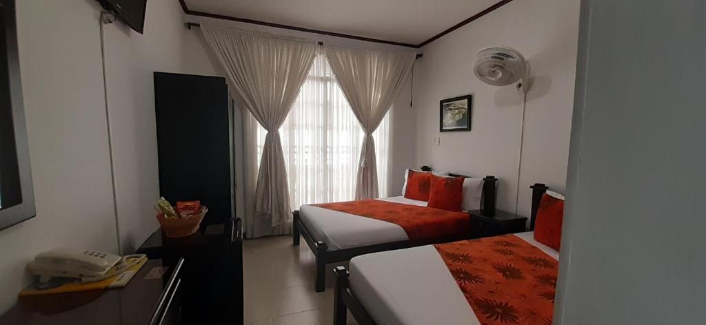 Postel nebo postele na pokoji v ubytování Hotel Colonial