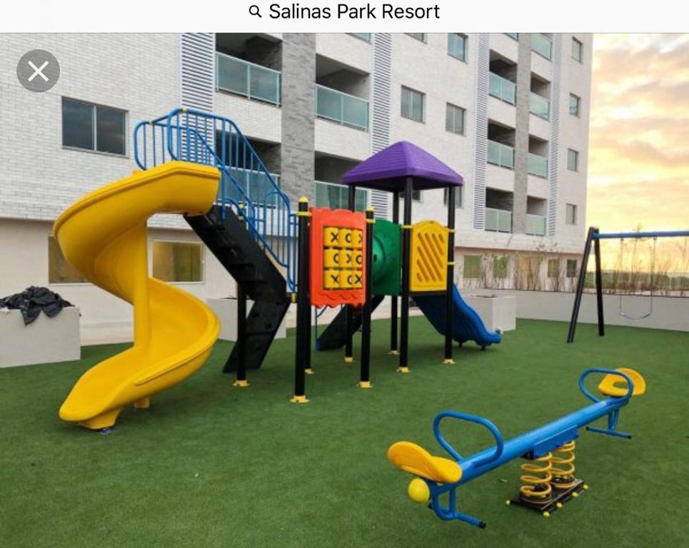 a playground with a slide and a slide at Salinas Park Resort in Salinas