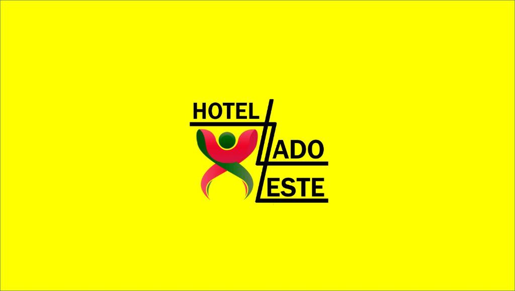 een logo voor een hotel met een roze lint bij Hotel Lado Leste in Sao Paulo
