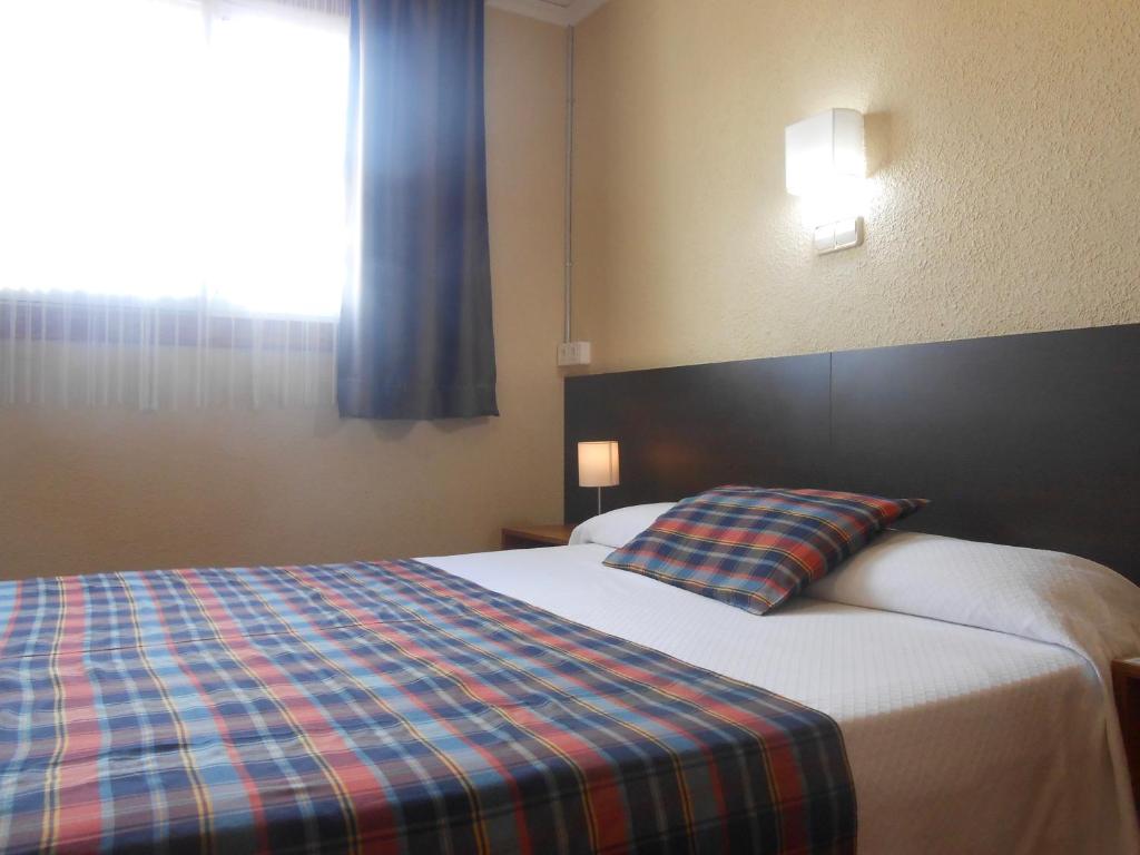 Postel nebo postele na pokoji v ubytování Hostal El Callejón