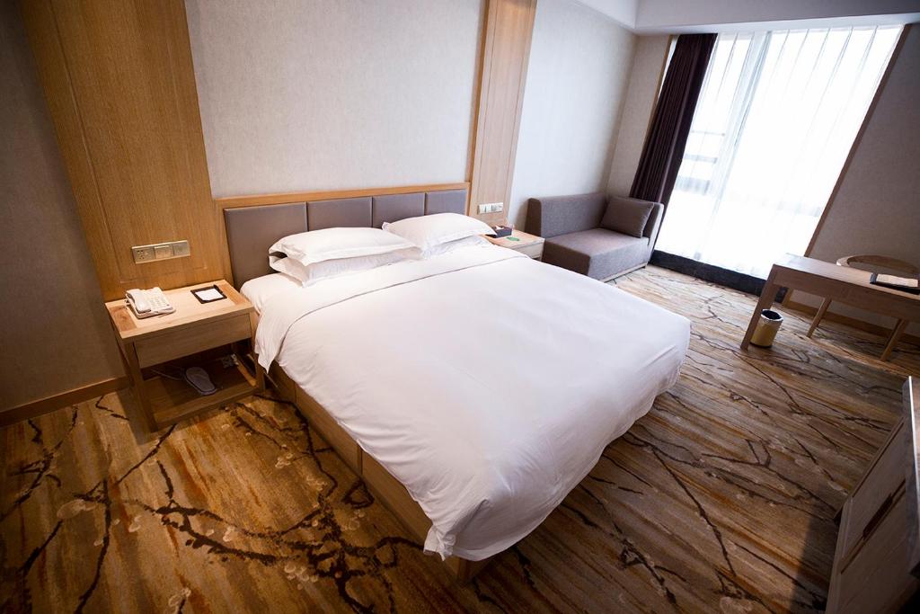 Postel nebo postele na pokoji v ubytování Metropark Hotel Yingkun Beijing