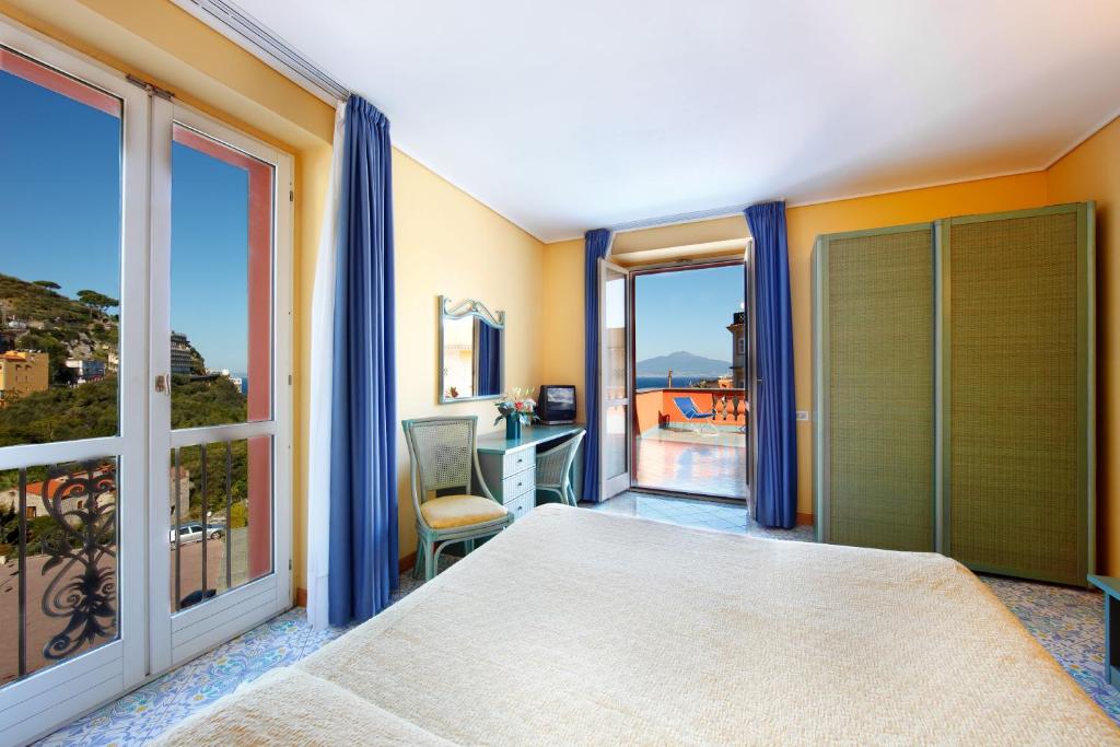 a bedroom with a bed and a window with a view at Hotel Villa Maria in Sorrento