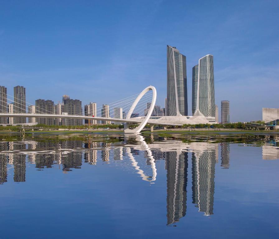 a white sculpture in front of a city with tall buildings at Jumeirah Nanjing Hotel in Nanjing