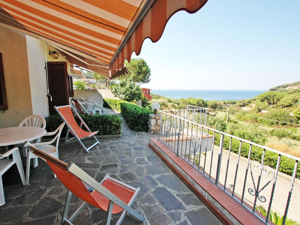 a balcony with a table and chairs and the ocean at Residence Antonella in Capoliveri