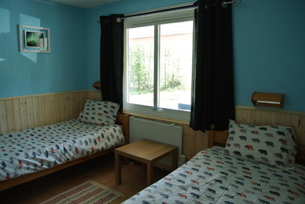 Postel nebo postele na pokoji v ubytování Arctic Colors Northern Lights Apartments