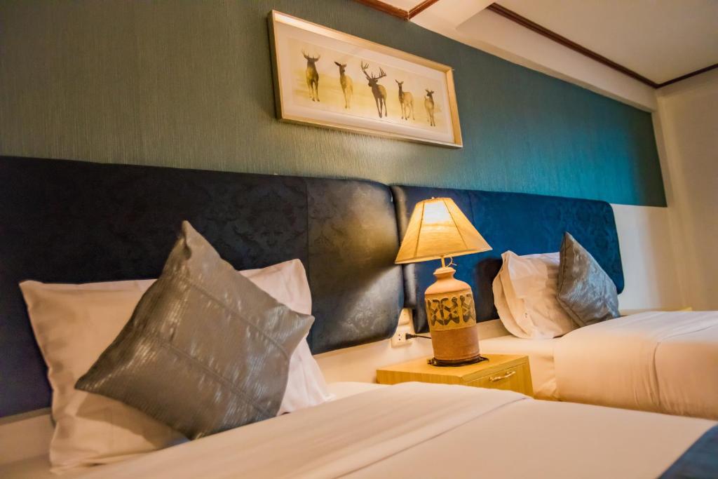 Кровать или кровати в номере Pro Andaman Place