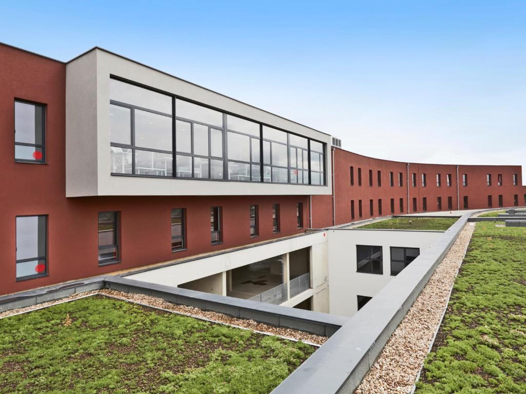 an external view of a red brick building at Tulip Inn Thionville Residences in Thionville