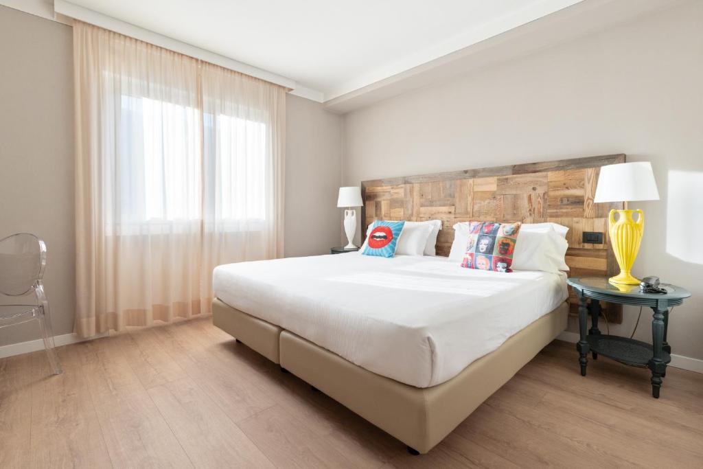 Postel nebo postele na pokoji v ubytování Hotel Leon d'Oro
