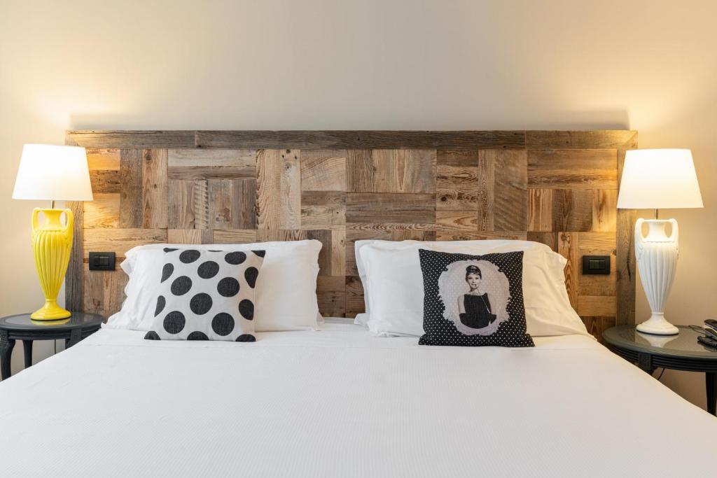 Postel nebo postele na pokoji v ubytování Hotel Leon d'Oro