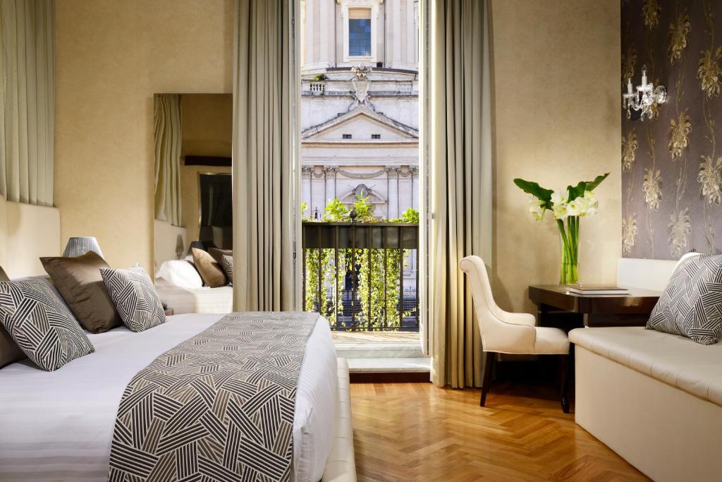 a hotel room with a bed and a desk and a window at Lifestyle Suites Rome in Rome