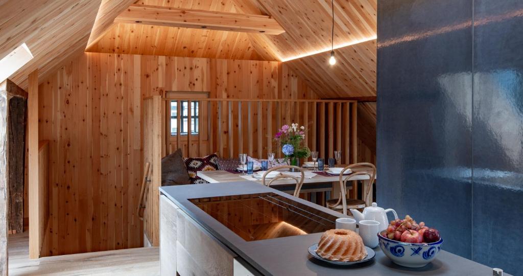 a kitchen with wooden walls and a table with fruit on a counter at das Stieger in Maishofen