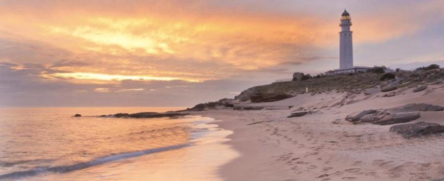 a lighthouse on a beach with the ocean at Trafalgar Polo Club in El Palmar
