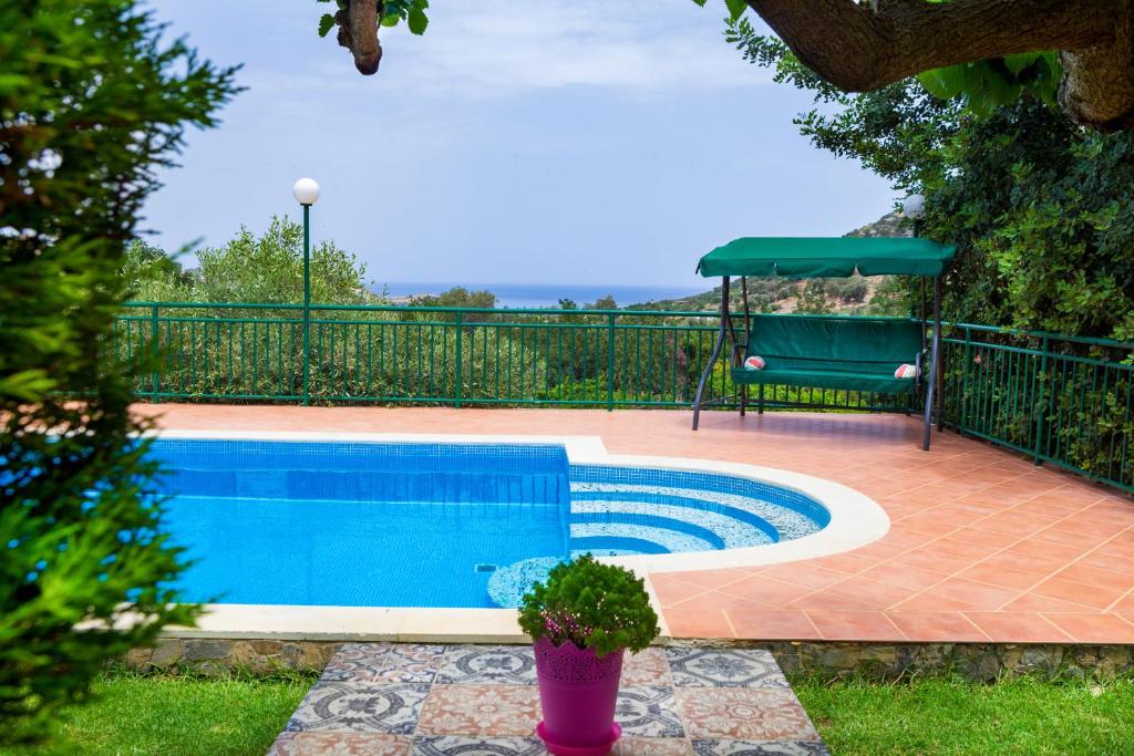 a swimming pool in a yard with a fence at Amari Villa, beach hideaway, By ThinkVilla in Vlikhádha