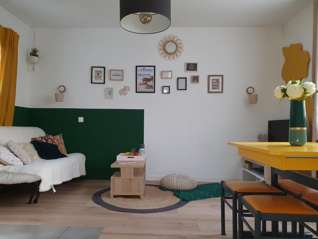 a living room with a couch and a table at L'Appart' à la Mer in La Guérinière