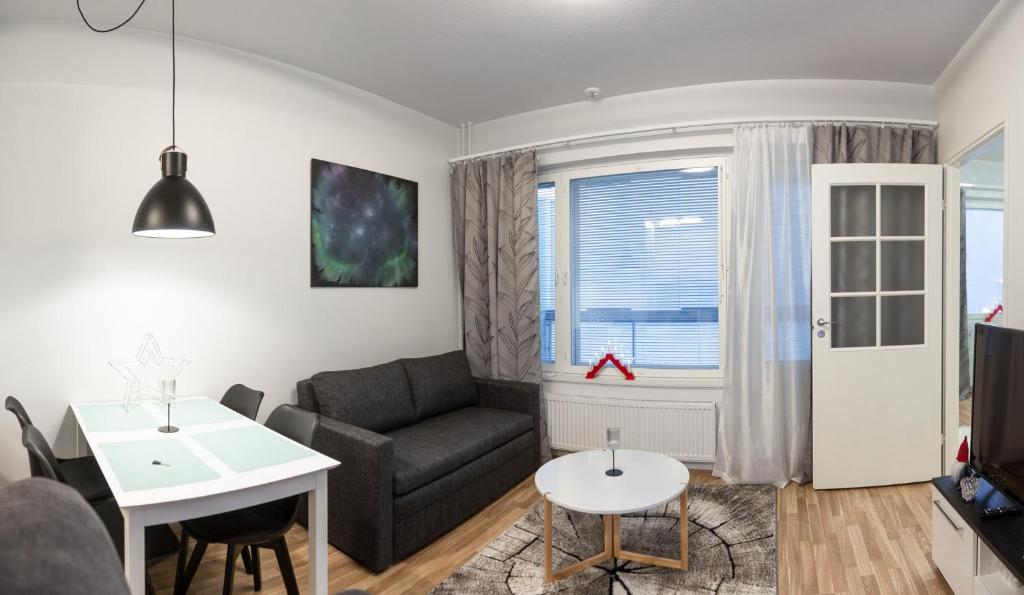 a living room with a couch and a table at Apartment Laura A6 in Rovaniemi