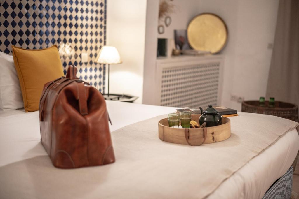 Ein Bett oder Betten in einem Zimmer der Unterkunft Riad Palais Calipau