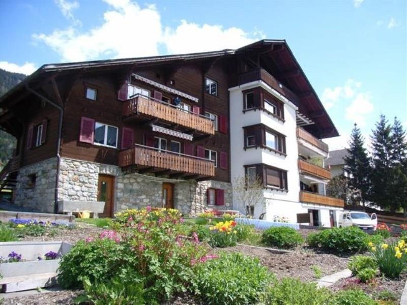 a large building with balconies on the side of it at Chalet Rezia in Savognin