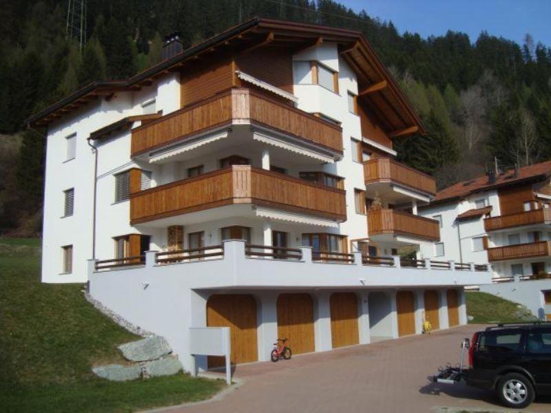 a large white building with wooden balconies on it at Sot Spondas 15 in Savognin