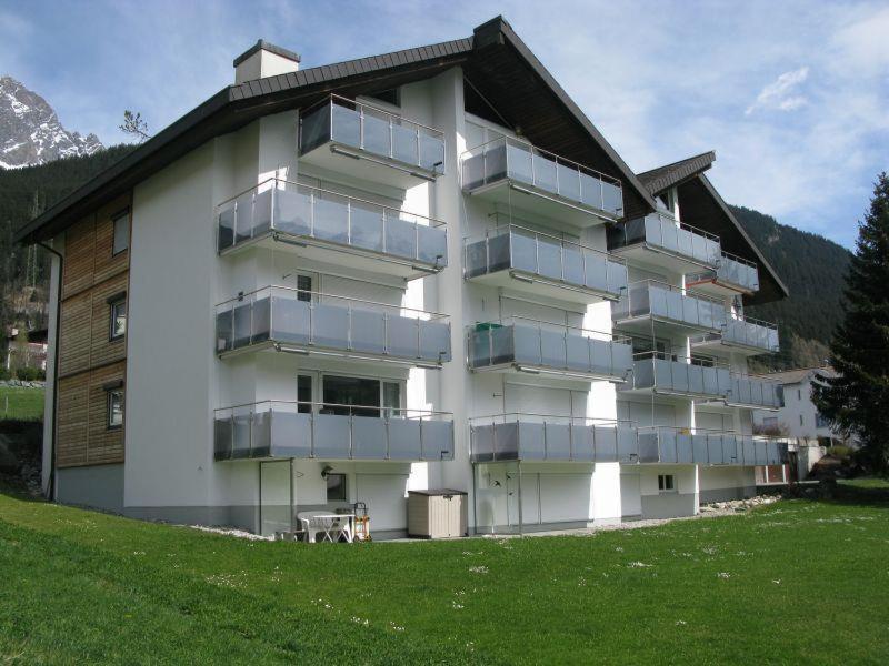a large building with balconies on the side of it at Tgesa La Niva 1 in Savognin