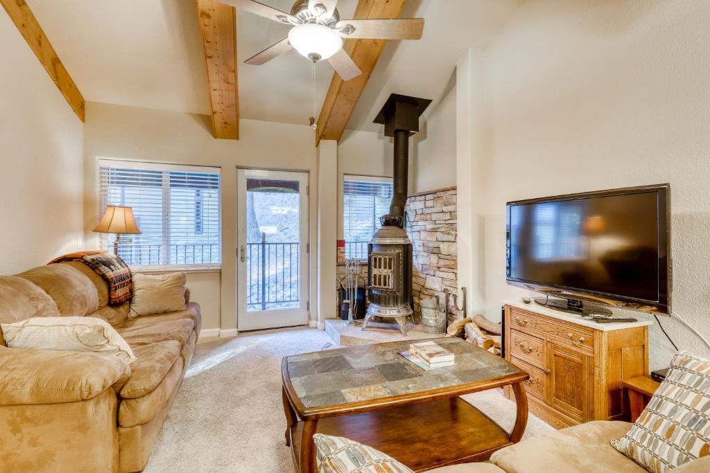 a living room with a large flat screen tv at The Alpine Meadows in Alpine Meadows