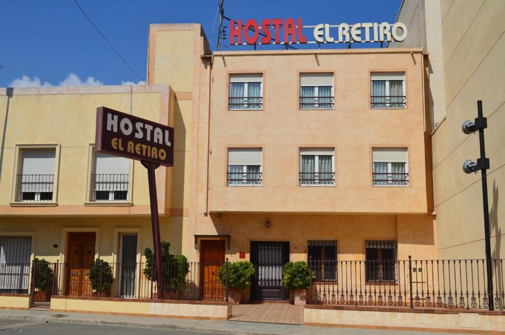 a hospital building with a sign on top of it at Hostal El Retiro in Almoradí