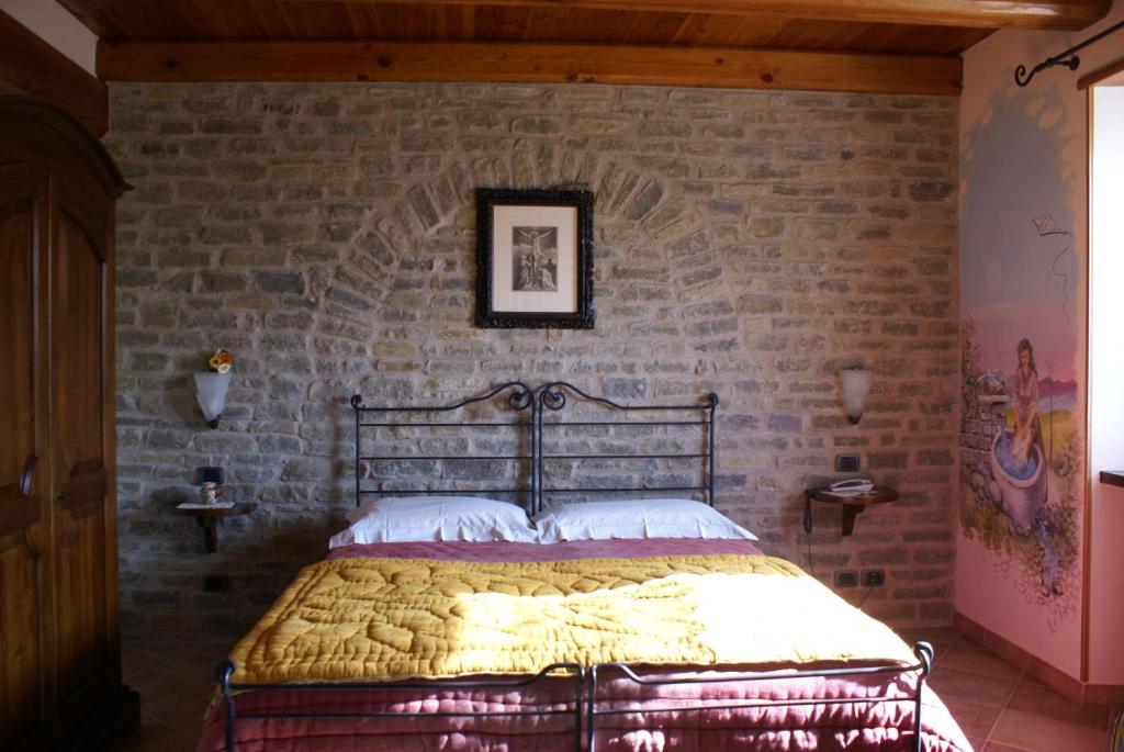 Postel nebo postele na pokoji v ubytování Agriturismo La Cascina