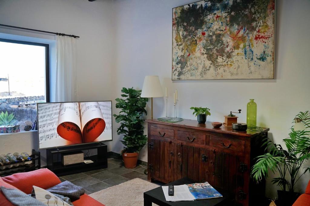 a living room with a couch and a tv at B&B La Mimosa in Teguise