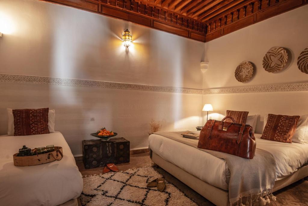Ein Bett oder Betten in einem Zimmer der Unterkunft Riad Palais Calipau