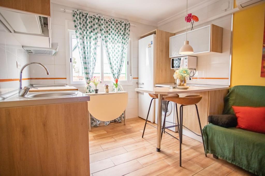 a small kitchen with a sink and a table at Casa Cobo Exclusivo Alojamiento en Madrid in Madrid