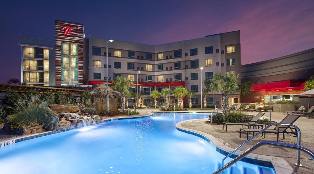 a pool in front of a hotel at night at Choctaw Casino Hotel - Grant in Grant