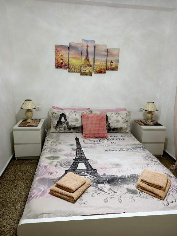 a bedroom with a bed with the eiffel tower on it at LA MAGIA DE PLAYA in Puerto de Sagunto